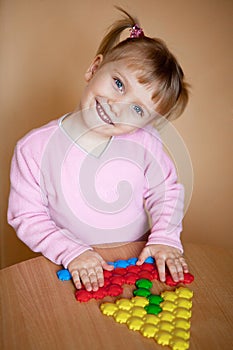 Small girl with toy mosaic