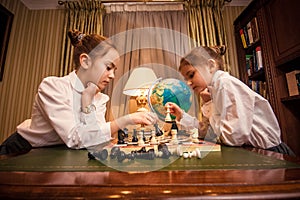 Small girls playing chess