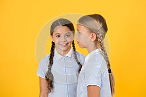 Small girls in retro uniform. old school fashion. back to school. happy beauty with pigtails. happy childhood. brunette
