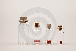 Small glass bottles with cork and reflexions