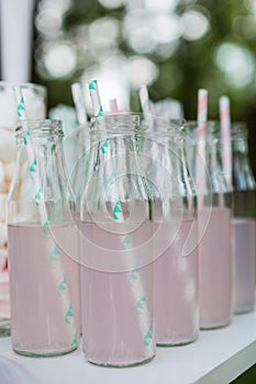 Small glass bottles with pink lemonade