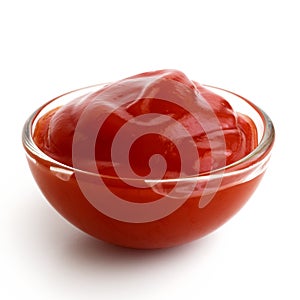 Small glass condiment bowl of red tomato sauce ketchup.