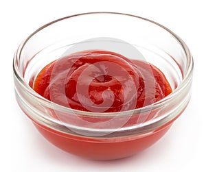Small glass condiment bowl of red tomato sauce ketchup. Isolated