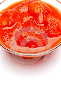 Small glass condiment bowl of red tomato sauce ketchup of peree