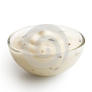 Small glass condiment bowl of white garlic and herb sauce. Isol