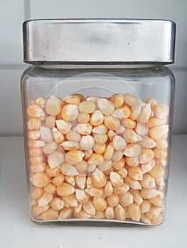 Small glass jar with metal lid with popcorn