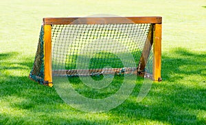 The small goal for the soccer on the green field