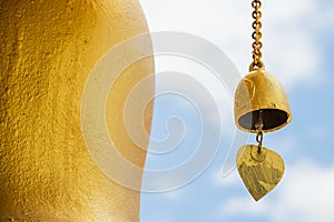 Small gold color of buddhist bell in the temple and blue sky ,Thailand.