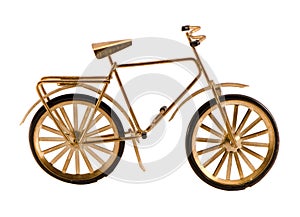 Small gold color toy bicycle isolated on white