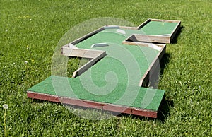 Small golf course built for children in a recreational space.