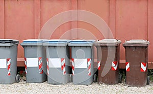 Small gray and brown plastic garbage cans