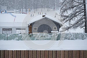 Small Gray Colored Wooden Hut Near the Ski Slopes on a Heavy Snow Day