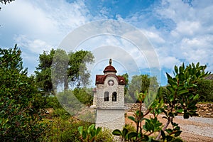 small greek christian orthodox chapel by the road among olive trees