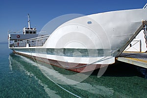 Small Greek ferry moored at the port of the charming Greek island of Antparos