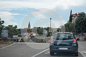 Small grey hatchback standing on an intersection in the town of Selca, small vilage on the island of Brac