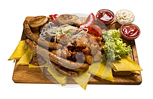 A small grill set on a wooden board. Isolated image on white background