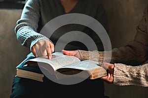 Small group of asian people praying worship believe. Teams of friends worship together before studying Holy bible. family praying