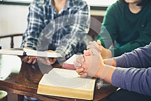 Small group of asian people praying worship believe. Teams of friends worship together before studying Holy bible. family praying