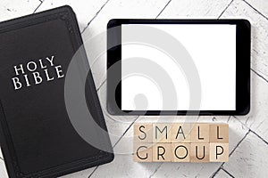 Small Group in Block Letters on a White Wooden Table with Bible and Tablet