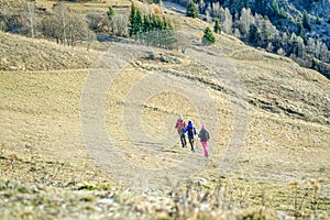 Small group of hikers friends doing trekking with backpack - Young tourist traveler reaching peak of the mountain - Sport,vacation