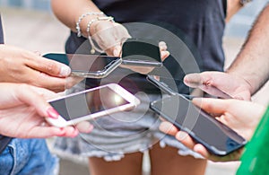 Small group of people using cellphones together