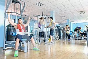 Small group of sportive friends at gym fitness club center