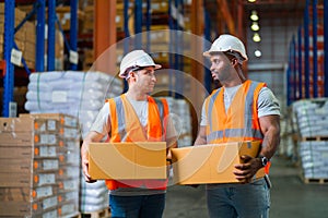 A small group of warehouse workers has a briefing in a large distribution center