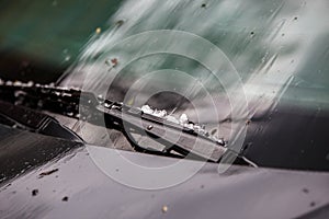 small hail ice balls on black car hood after heavy summer storm