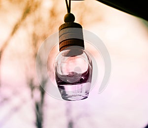 Small hanging bottle with orange and purple tones