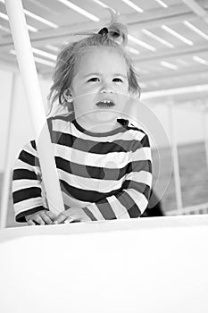 Small happy baby boy on yacht in marine shirt, fashion