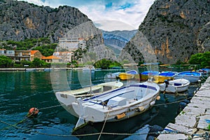 Small harbor with fishing and tourist boats in Omis, Croatia