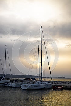 Small harbor with yachts and sail boats in at sunset