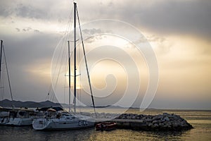 Small harbor with yachts and sail boats in at sunset