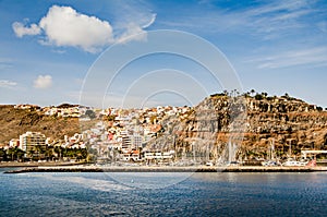 Small harbour town of San Sebastian de La Gomera. Houses on a hill. Summer vibe. Small harour with sailing yachts. Island