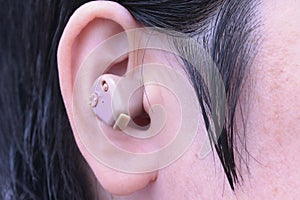 Small hearing aid put in the  right ear
