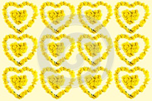 Small hearts made of dandelions, background of dandelions
