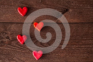 Small hearts on a wooden background. Valentine`s day concept