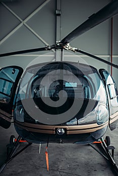 Small helicopter in hangar, private airline copter