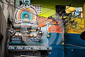 Small Hindu temple and chaotic electrical wires in the old city of Thiruchirappalli, Tamil Nadu, India