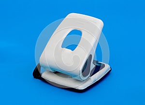 Small hole puncher on blue photo