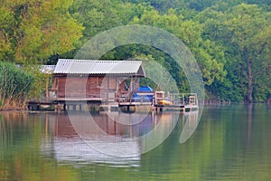 Small holidays cottage reflected in lake