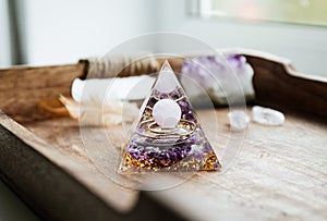 Small home altar with Orgonite or Orgone pyramid indoors.