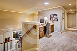 Small home office in the hallway with carpet floor photo