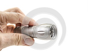 Small home pocket led flashlight in hand on the white.