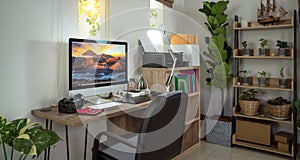 Small homeoffice for photographer with plants decor and Bromo Mt picture on the destop wall paper