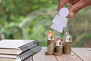 Small house on coin pile and investor. Investor investment.Stack money coin for growing your business.Investment, trading house