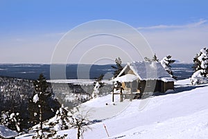 Small house on the hill in winter