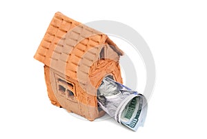 Small house made of clay and money