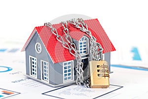 Small house model locked by chains