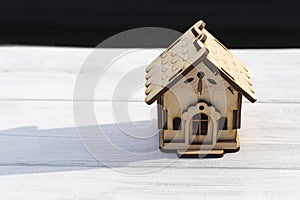 small house model over wooden table outdoors at garden selective focus . filtered image